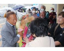町役場前に集まった支持者から花束を受け取る大江康弘町長（左）＝１３日、和歌山県白浜町で