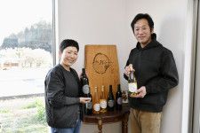 自家栽培するブドウで醸造したワインの販売を始めた吉村潔さん（右）と妻の慎子さん＝2024年3月、宇都宮市