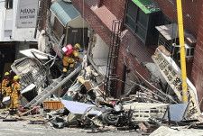 台湾東部・花蓮の倒壊した建物で、連絡の取れない人の捜索を続ける消防隊員＝3日（中央通信社＝共同）