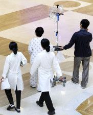 19日、ソウルの大学病院内を歩く患者と医療関係者ら（聯合＝共同）