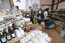 石川県珠洲市で営業を再開した「道の駅すずなり」で、買い物を楽しむ客ら＝28日午前