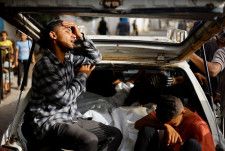 イスラエル軍の攻撃による犠牲者の遺体を前に嘆く人々＝27日、ガザ地区南部ラファ（ロイター＝共同）