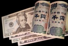 　４月１０日、為替円安を受けて通貨当局のけん制発言が目立ってきた。ただ、強すぎる口先介入は日銀による追加利上げの連想を誘発し、景気回復の流れに水を差すリスクもはらむ。写真は米ドルと日本円紙幣。２０２２年９月撮影のイメージ写真（２０２４年　ロイター/Florence Lo/Illustration）